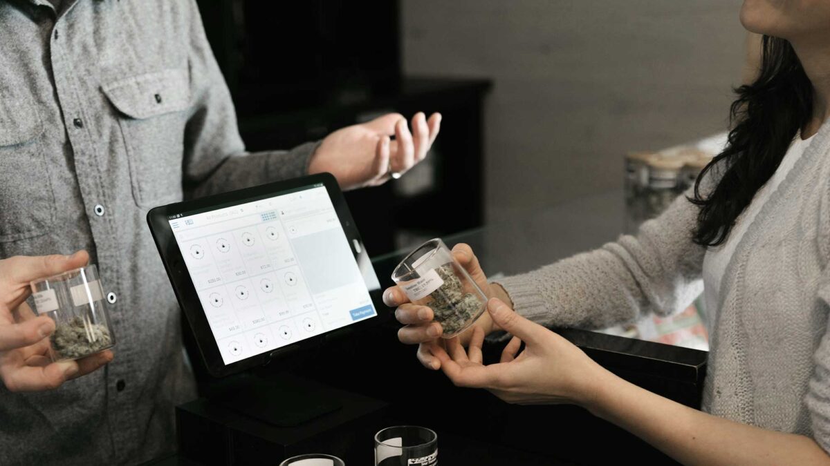 Cannabis business owner working with a customer